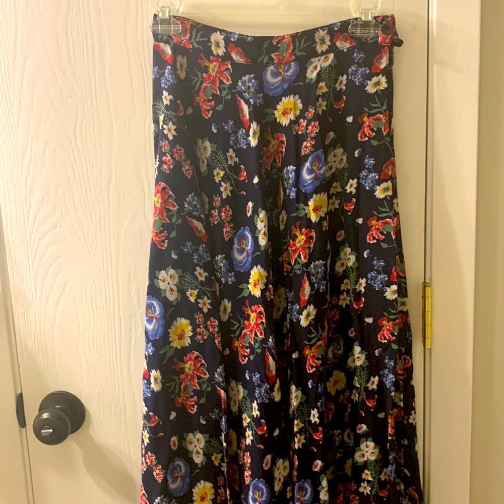 Dark blue, floral print skirt. One button, side zipper. Flares when twirling.